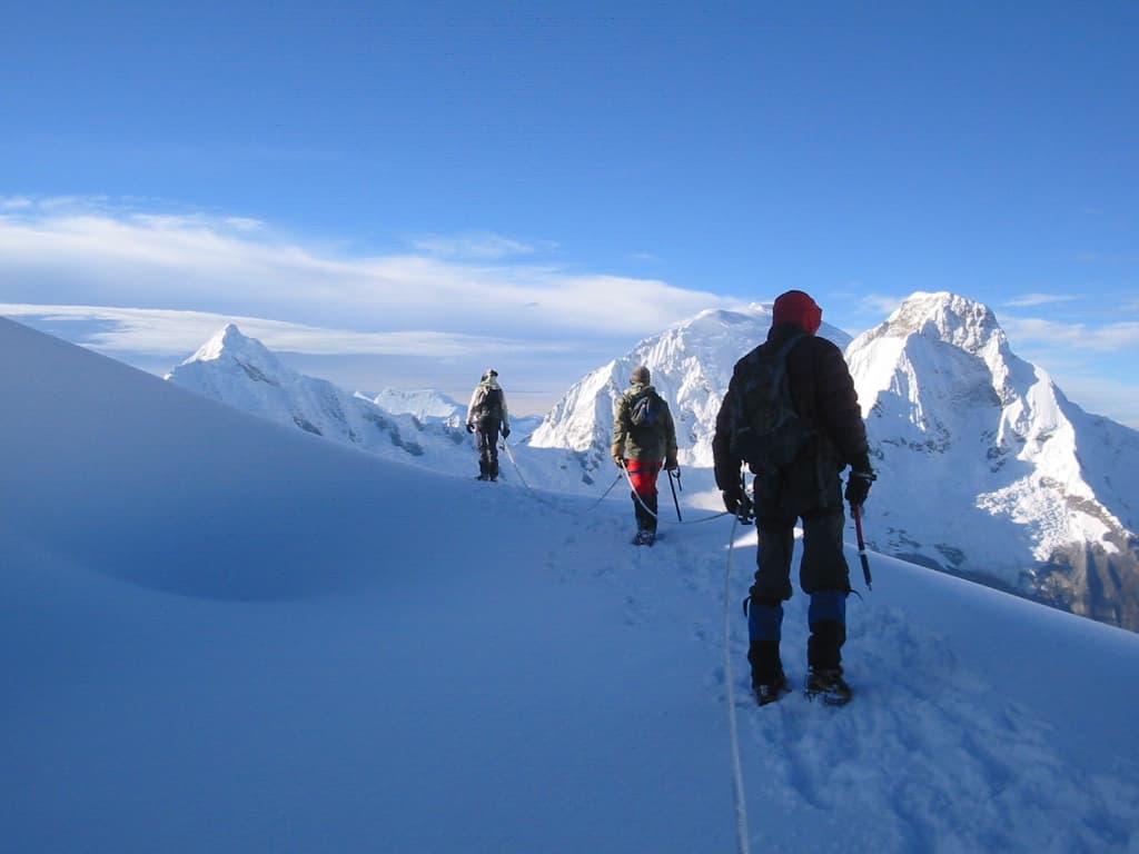 Grupo de viajeros contemplando la cadena montañosa.